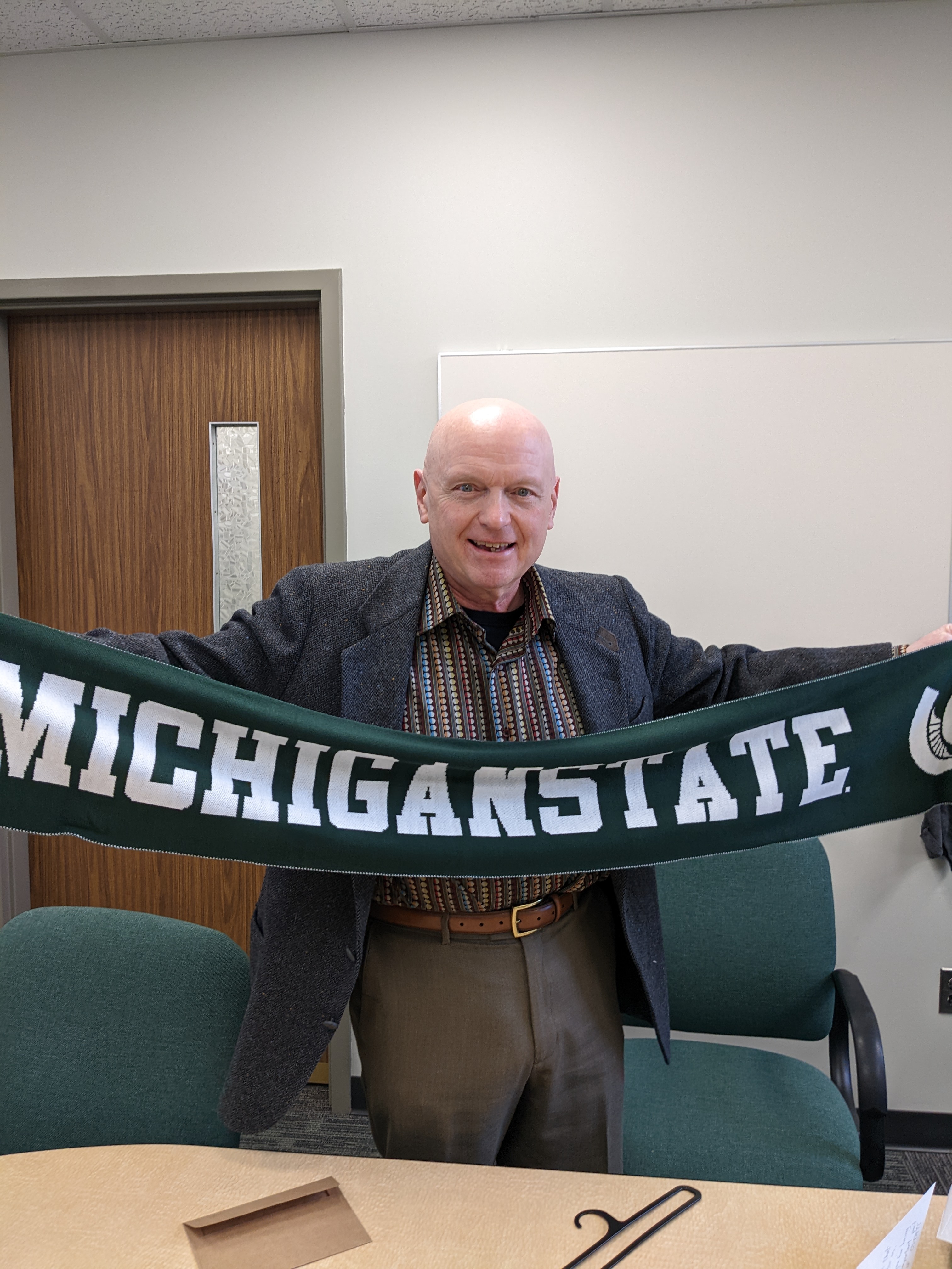 Frank Lawrence holding MSU banner