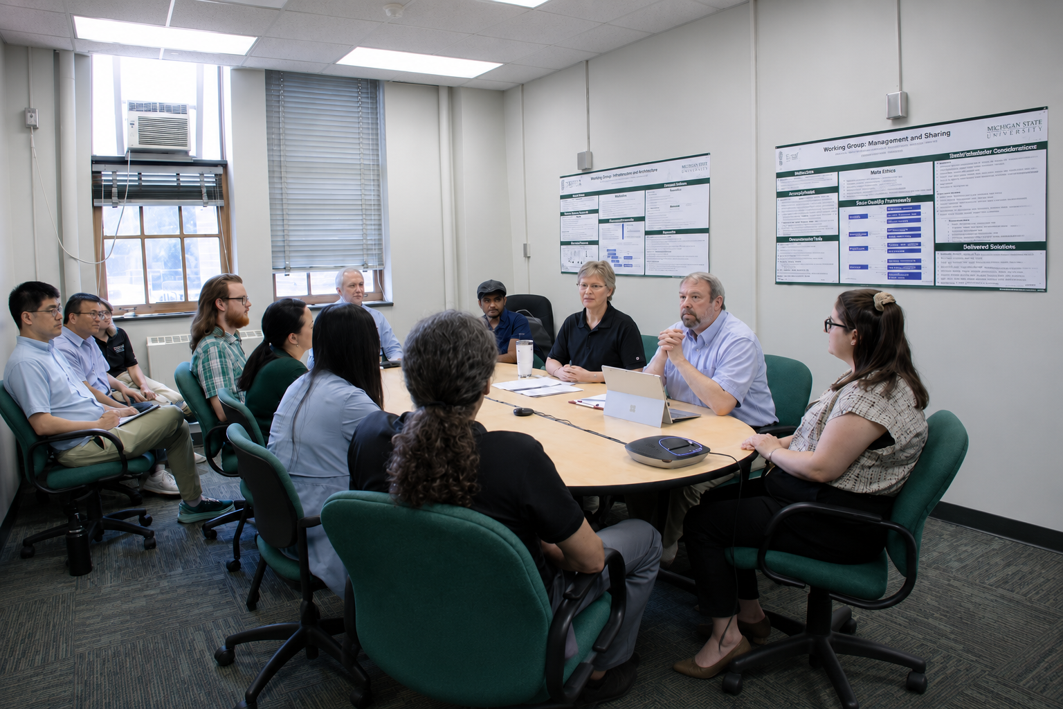 CSTAT team members meet around a conference table in an office setting.